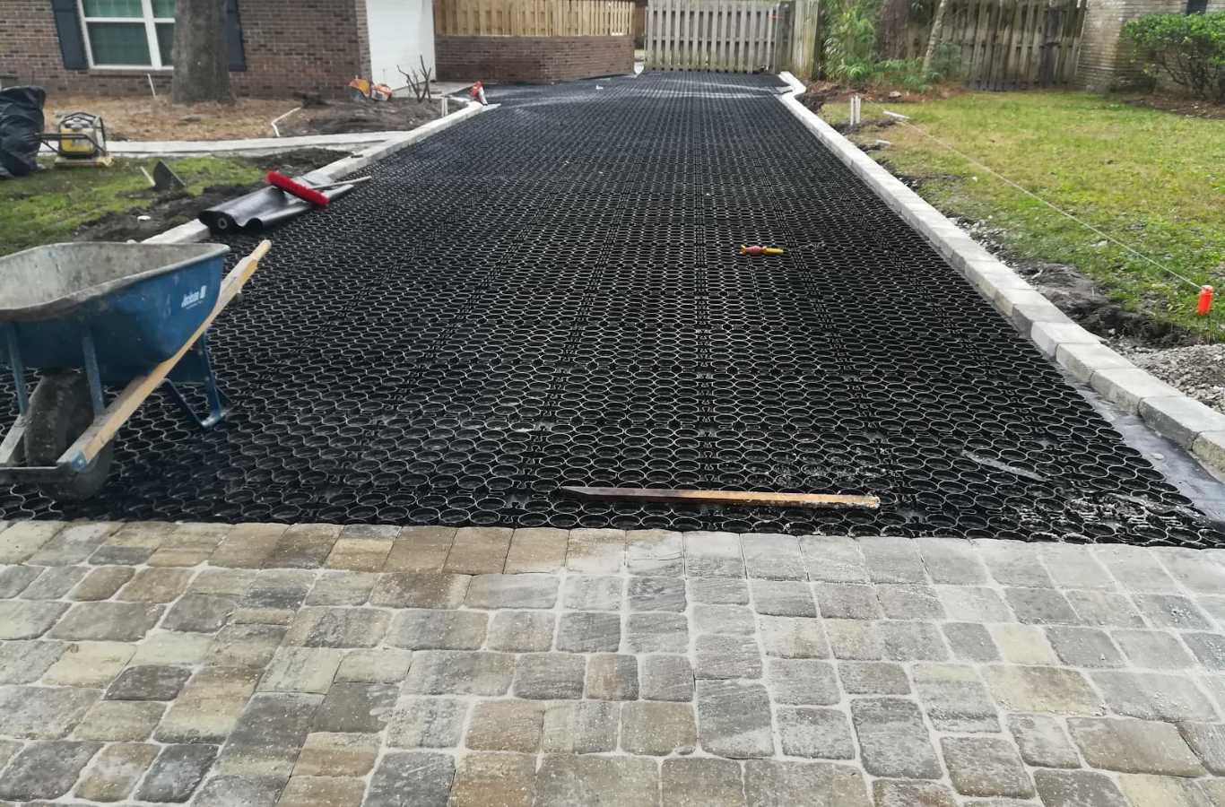 A FARE Outdoor Construction team member explaining the advantages of their driveway paving services in Hoover, AL. Driveway Paving Near Me.